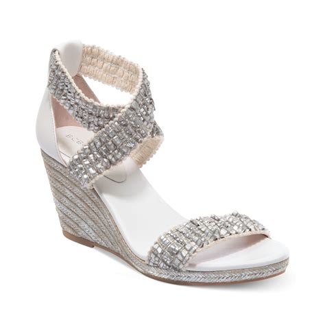 silver metallic wedge heels.